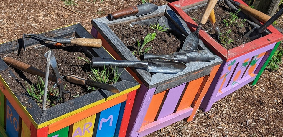 Planters display the gardening tools transformed by the Guns 2 Gardens organization.