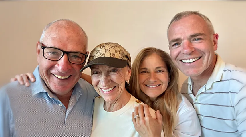 The four members of the Boucher and McManus family huddle together, smiling, for a selfie.
