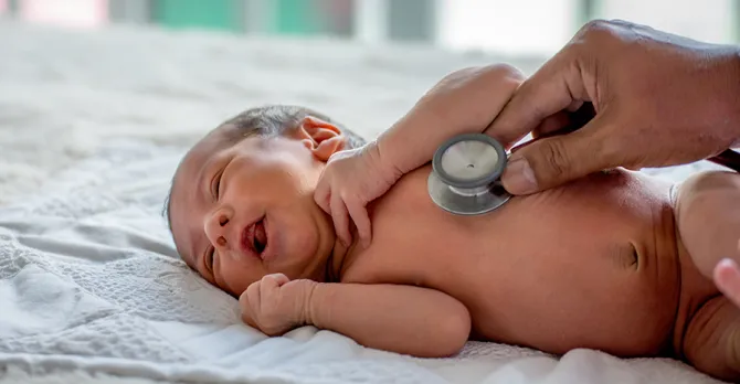 Soft blur of the doctor hands use stethoscope to check newborn baby health