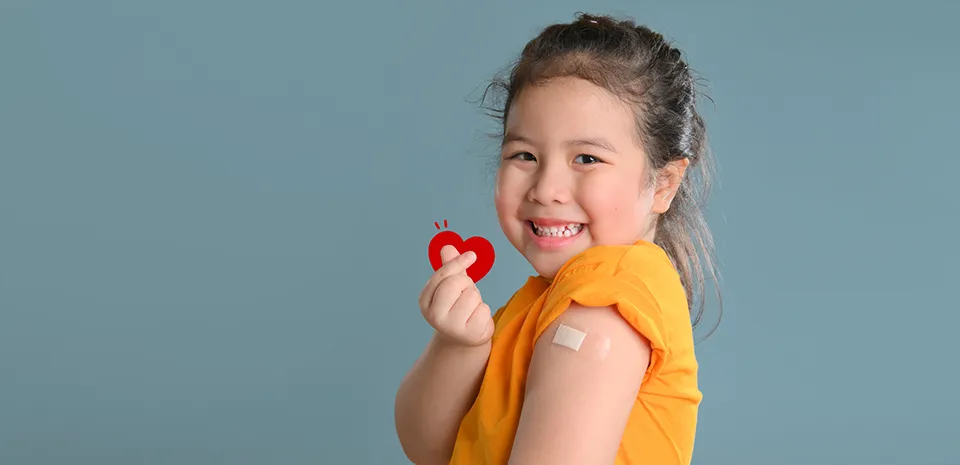 happy girl with bandaid after shot