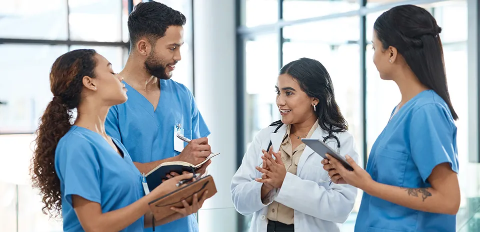 A doctor has a discussion with 3 staff members.