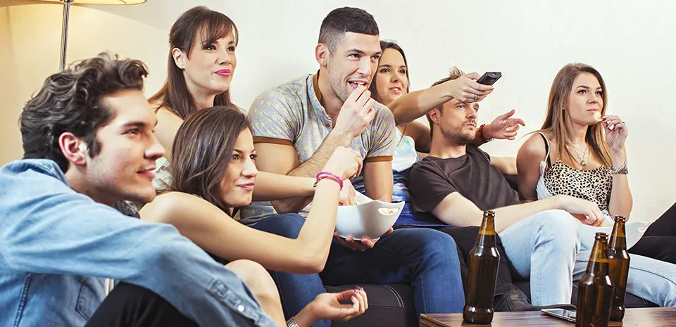 young adults drinking on couch