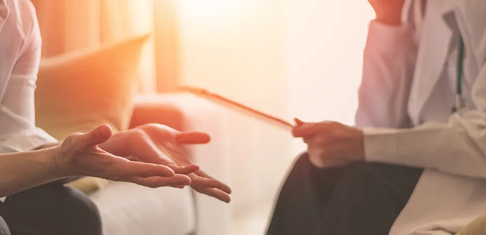 doctor and patient during a therapy session discussing treatment plan