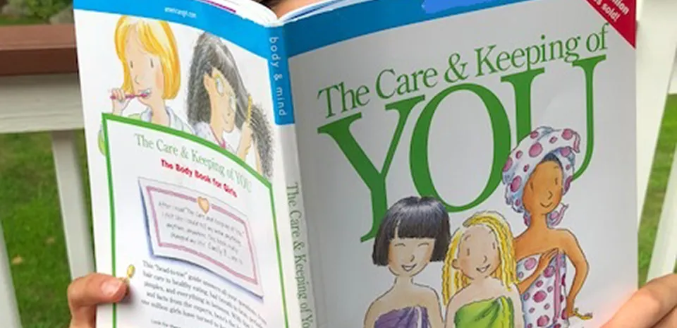 teen reading a book about puberty