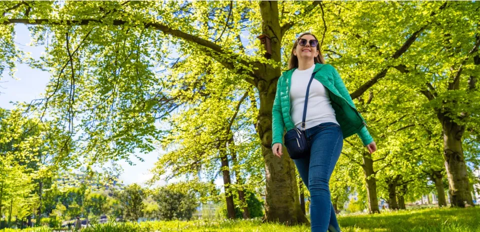 woman in jeans walking mindfully in a spring woods