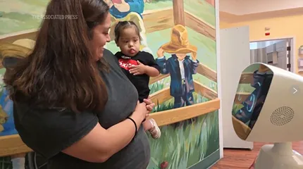 Robin the Robot interacts with a pediatric patient who smiled and waved at her.