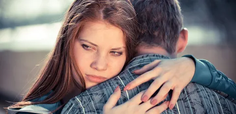 teens in a relationship hugging