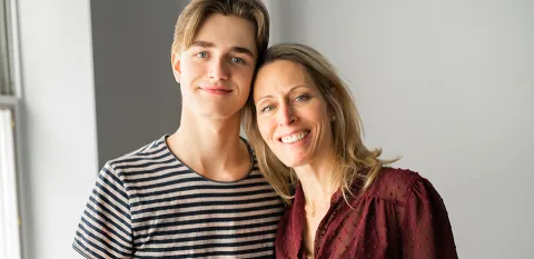 teen boy and mom at college dorm room