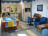 The air hockey game and comfortable chairs are part of the game room at Shelly's Place.
