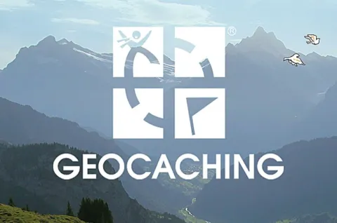 A mountain range is shown with the text 'Geocaching' and the Geocaching.com logo.