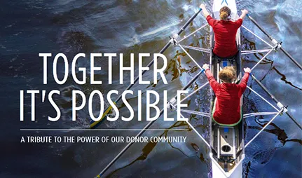 Two young women practice rowing together in a regatta boat.