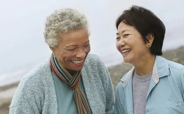 two elder women enjoying time together and laughing 