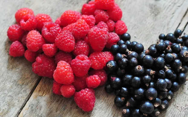 raspberries and blueberries shaped in hearts