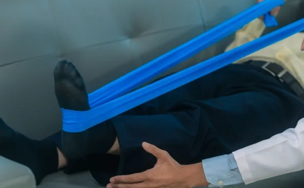 Man lying on couch doing physical therapy after same day joint replacement