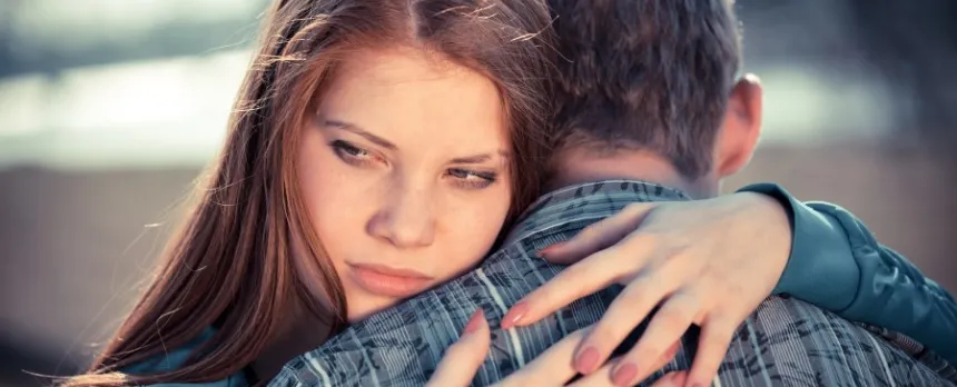 A worried teen victim of dating abuse hugs boyfriend