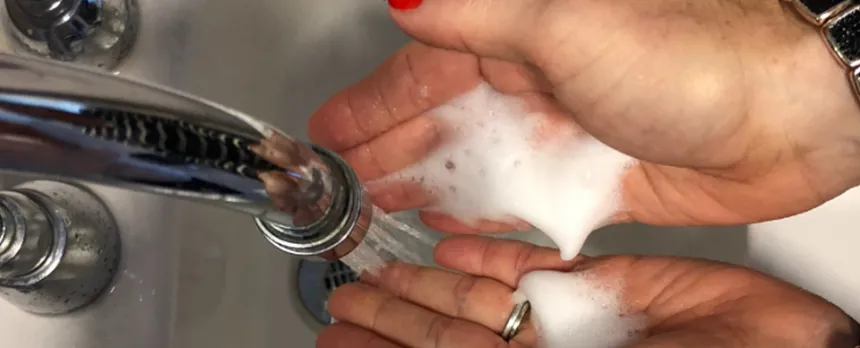 A woman's hands in the sink as she washes them