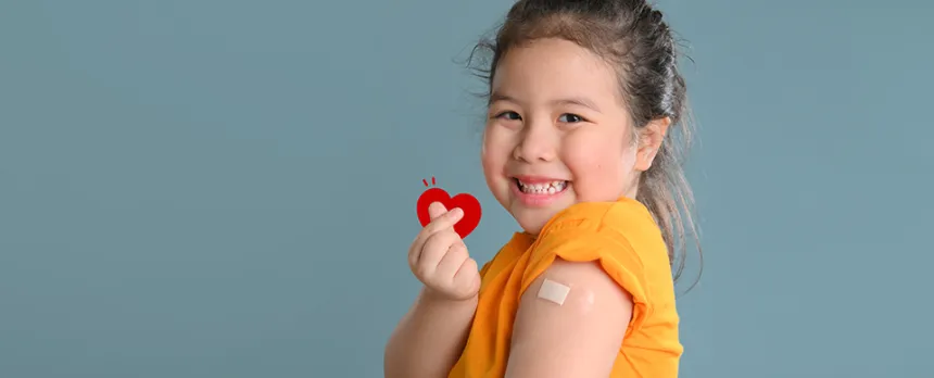 happy girl with bandaid after shot