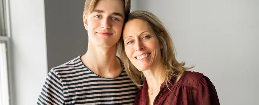 teen boy and mom at college dorm room