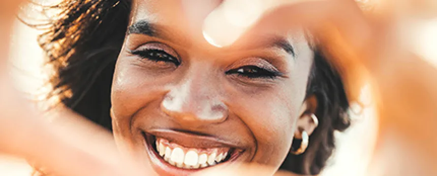 Image of woman making a heart with her hands